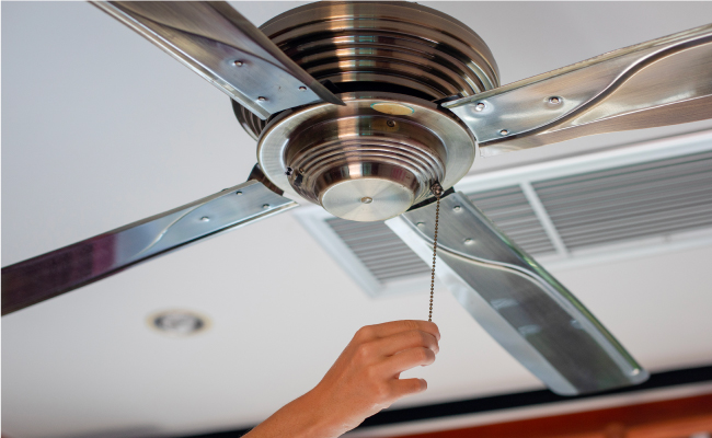 handyman repairing ceiling fan
