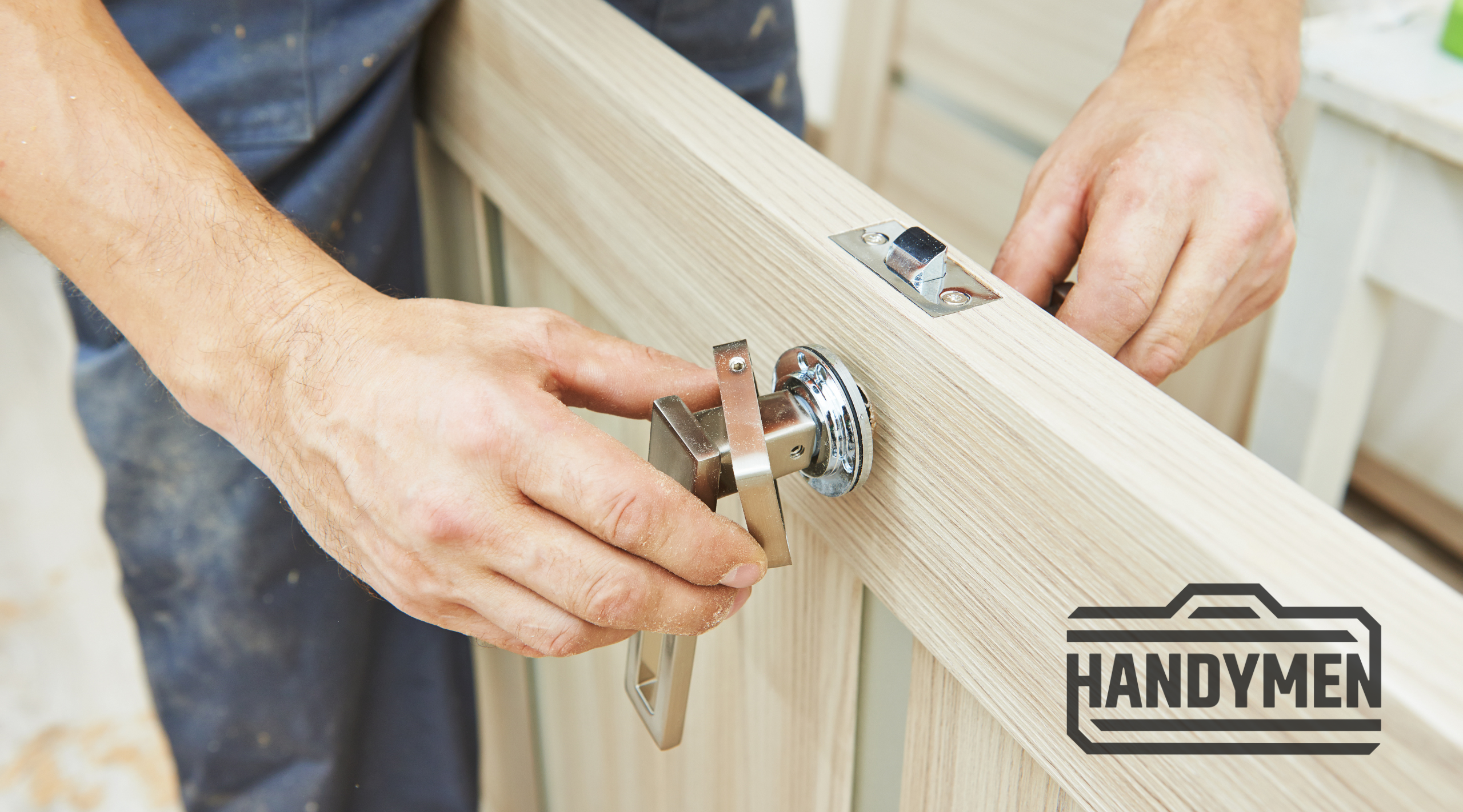 A photo of a Handymen employee fixing a doorknob and hardware to a new door.